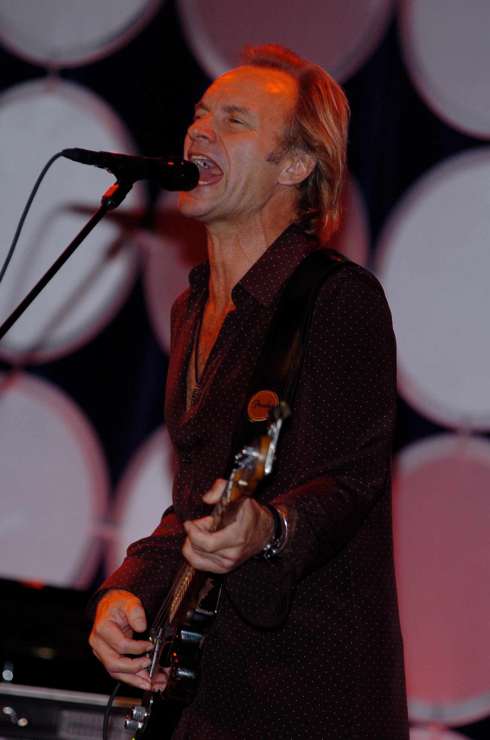Live musician performing with guitar onstage