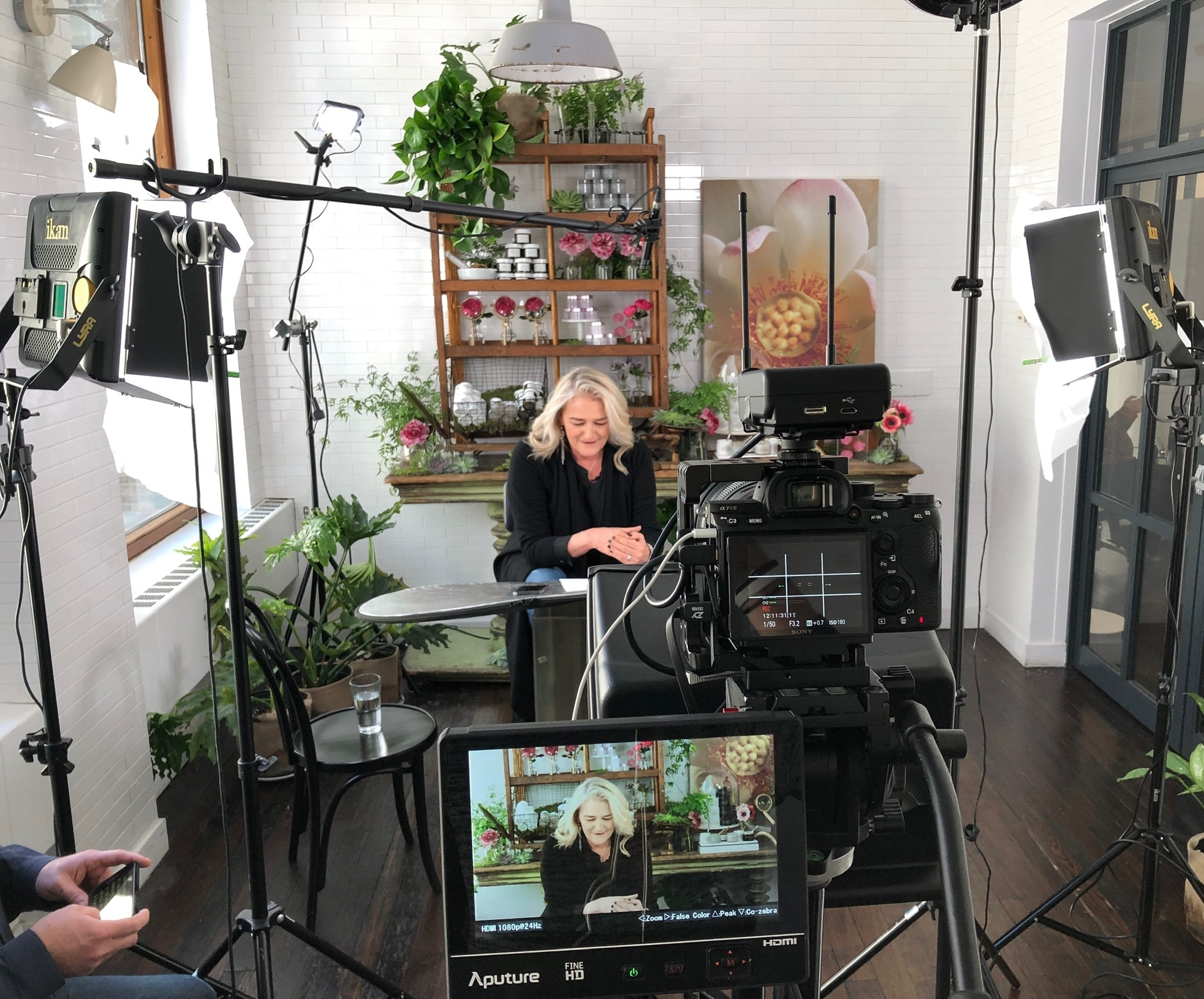 Interview production setup with cameras, lighting, and a seated guest