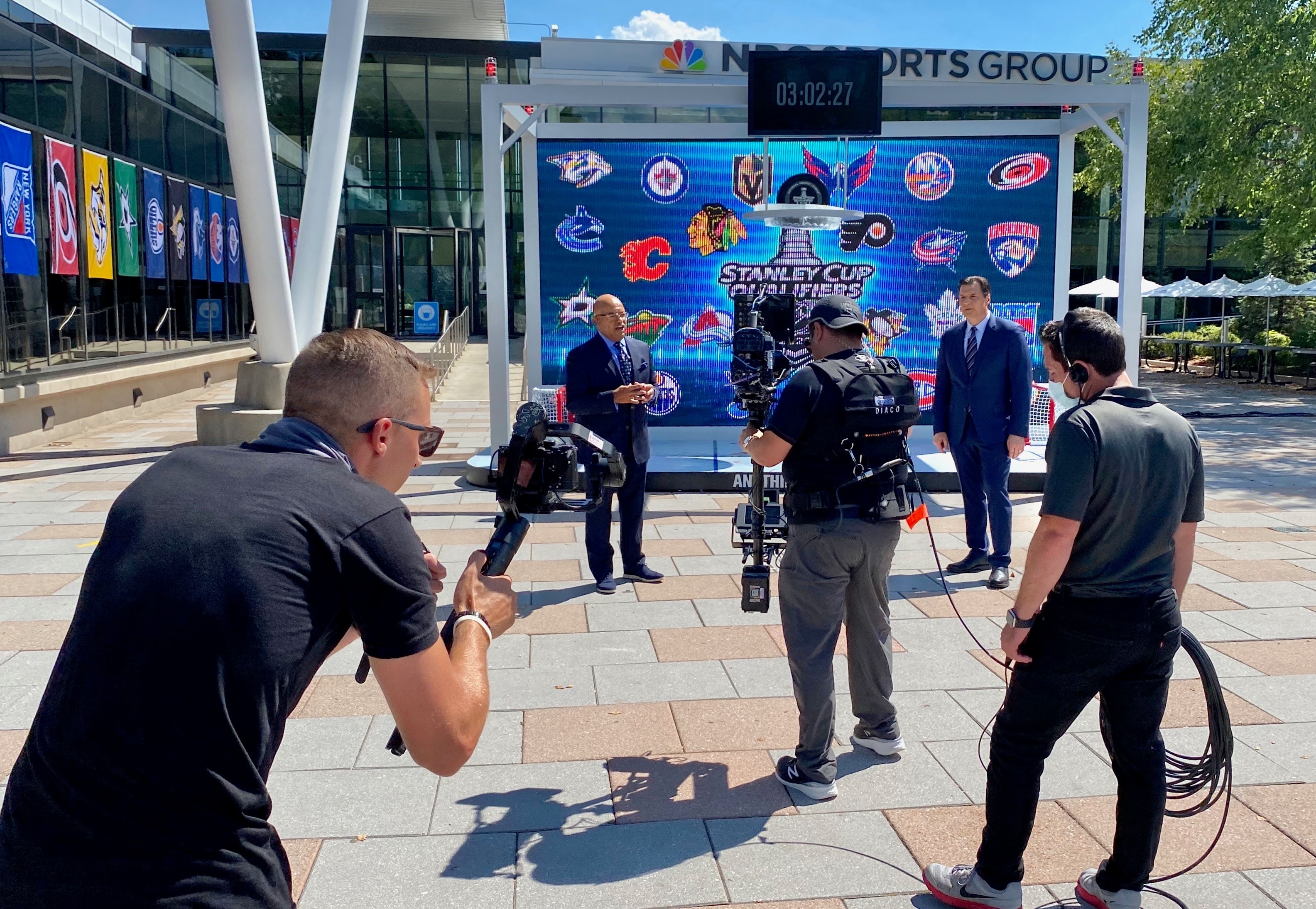 Production crew filming an NBC Sports Group event outdoors
