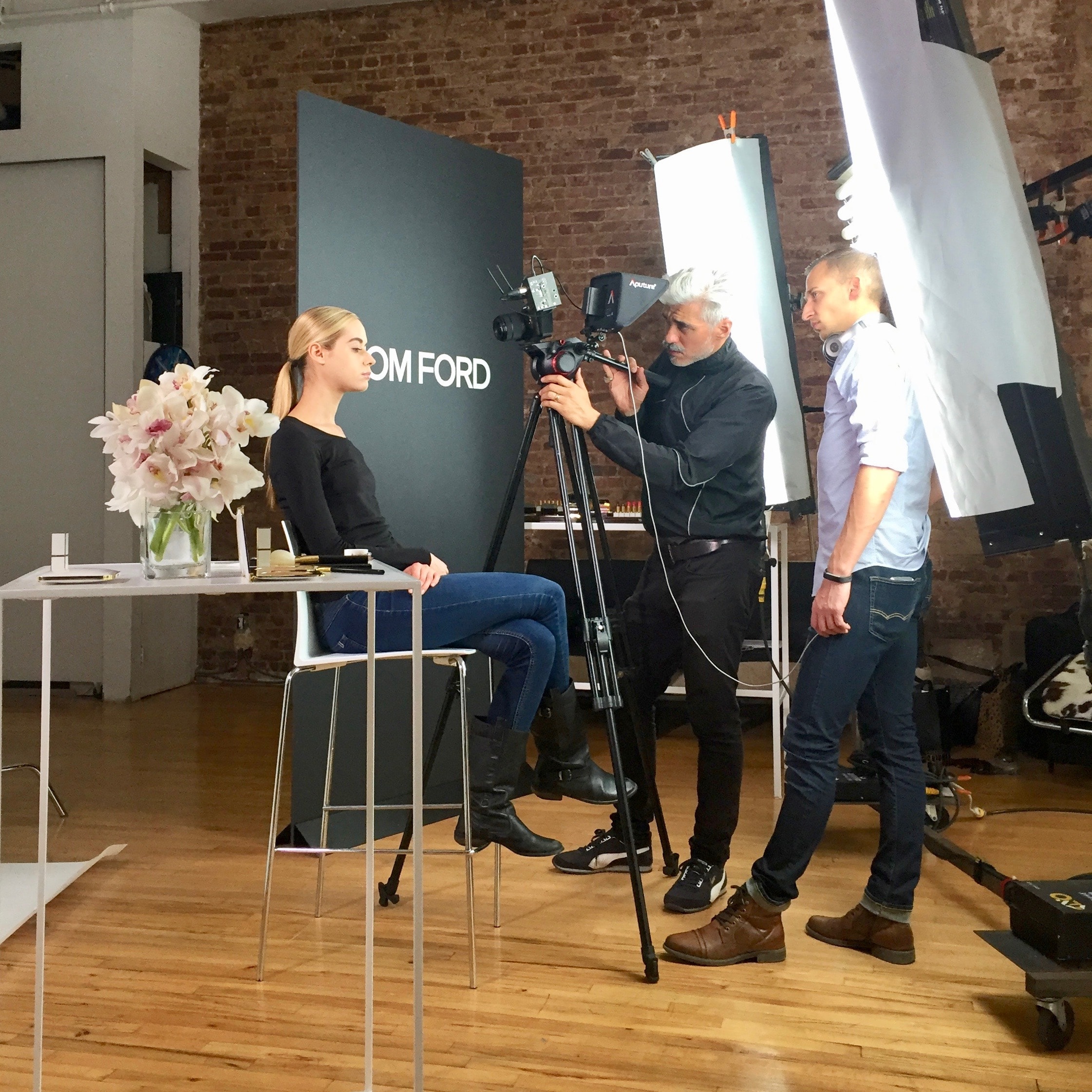 Camera crew filming a model during a Tom Ford studio shoot