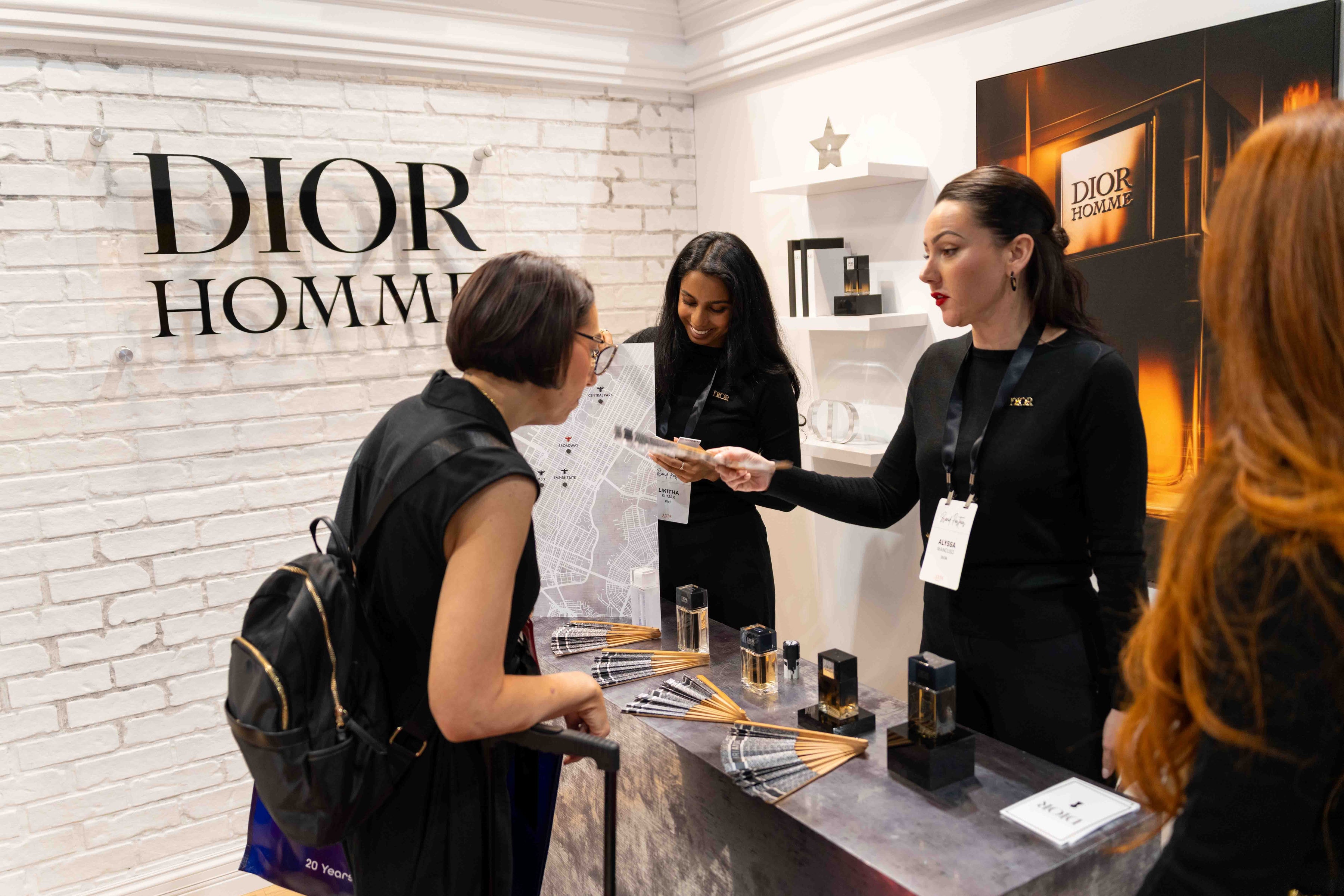 Dior Homme staff assisting customer at fragrance counter
