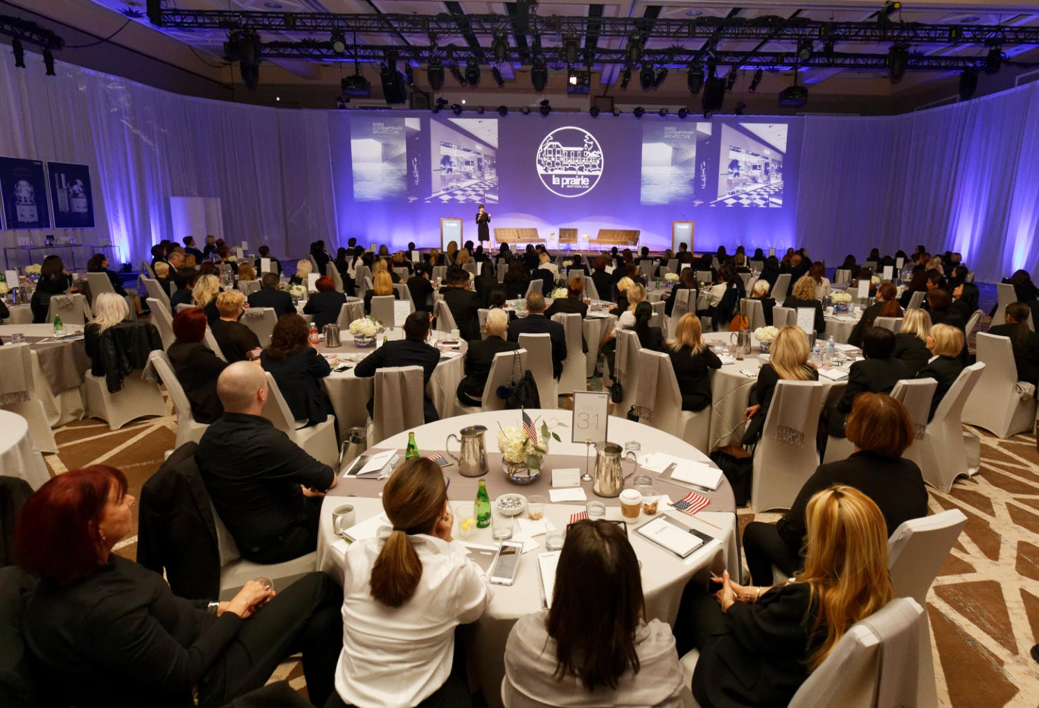 Business conference audience seated at tables