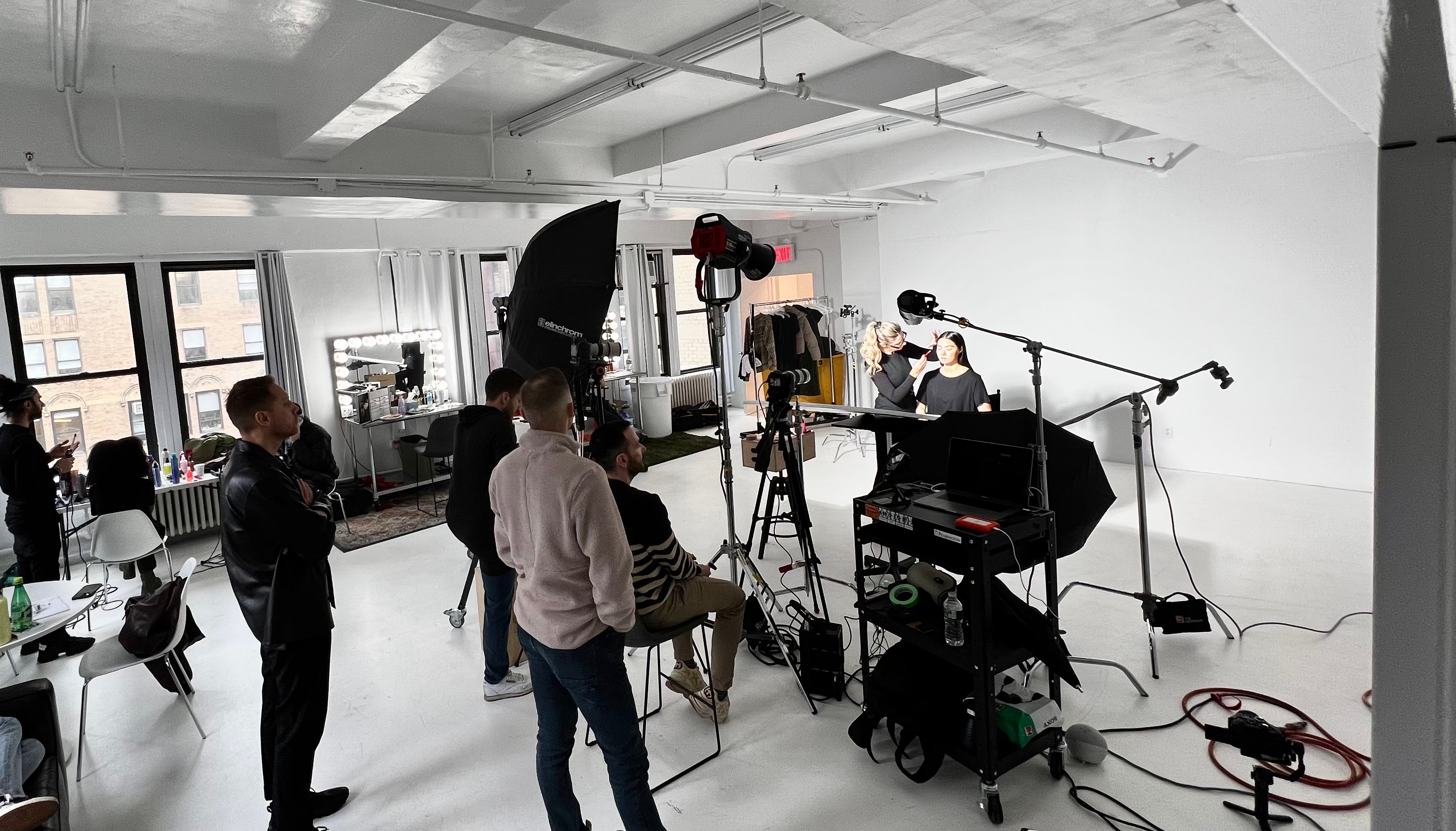 Film crew photographing makeup model in studio