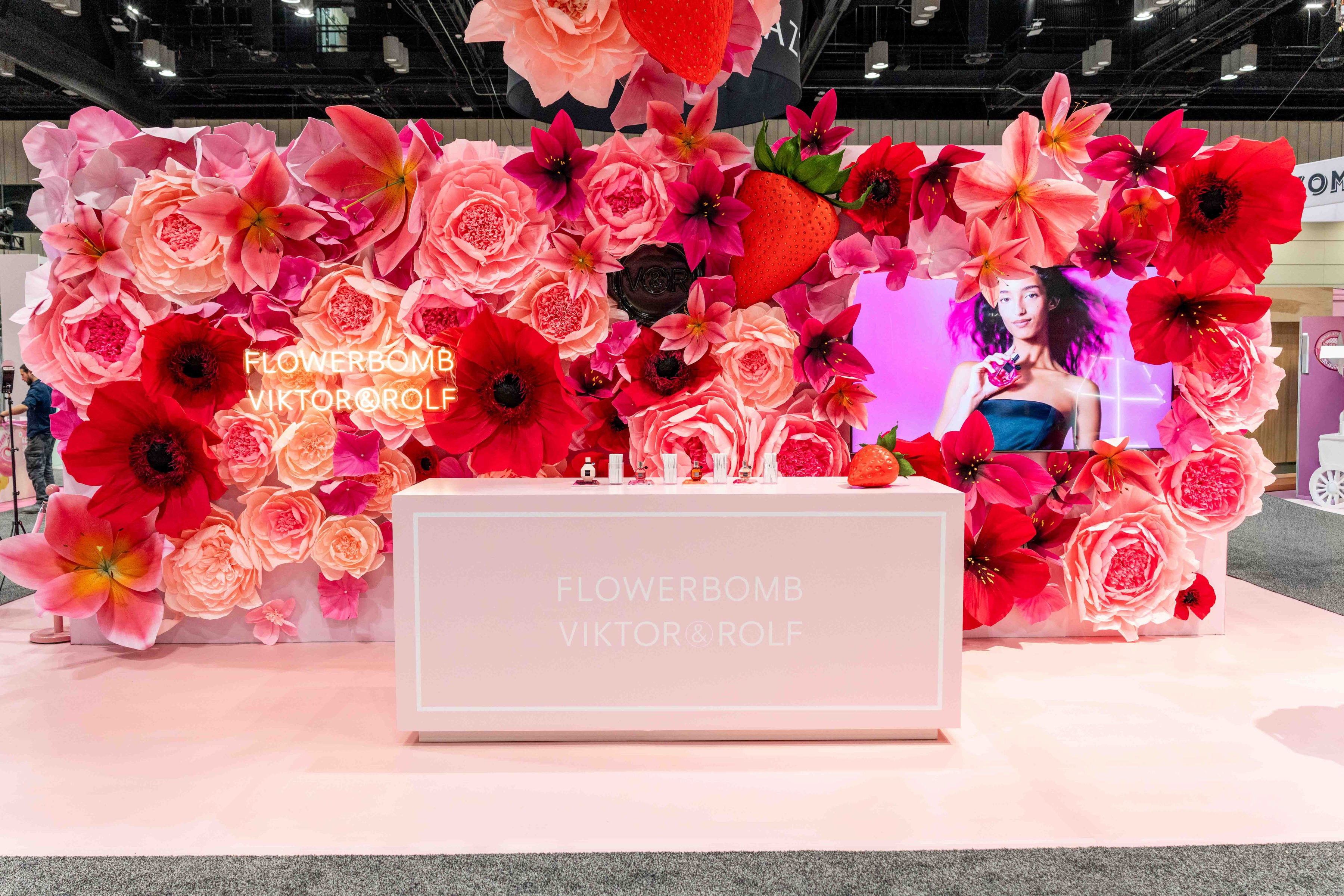 Flowerbomb perfume display surrounded by flowers