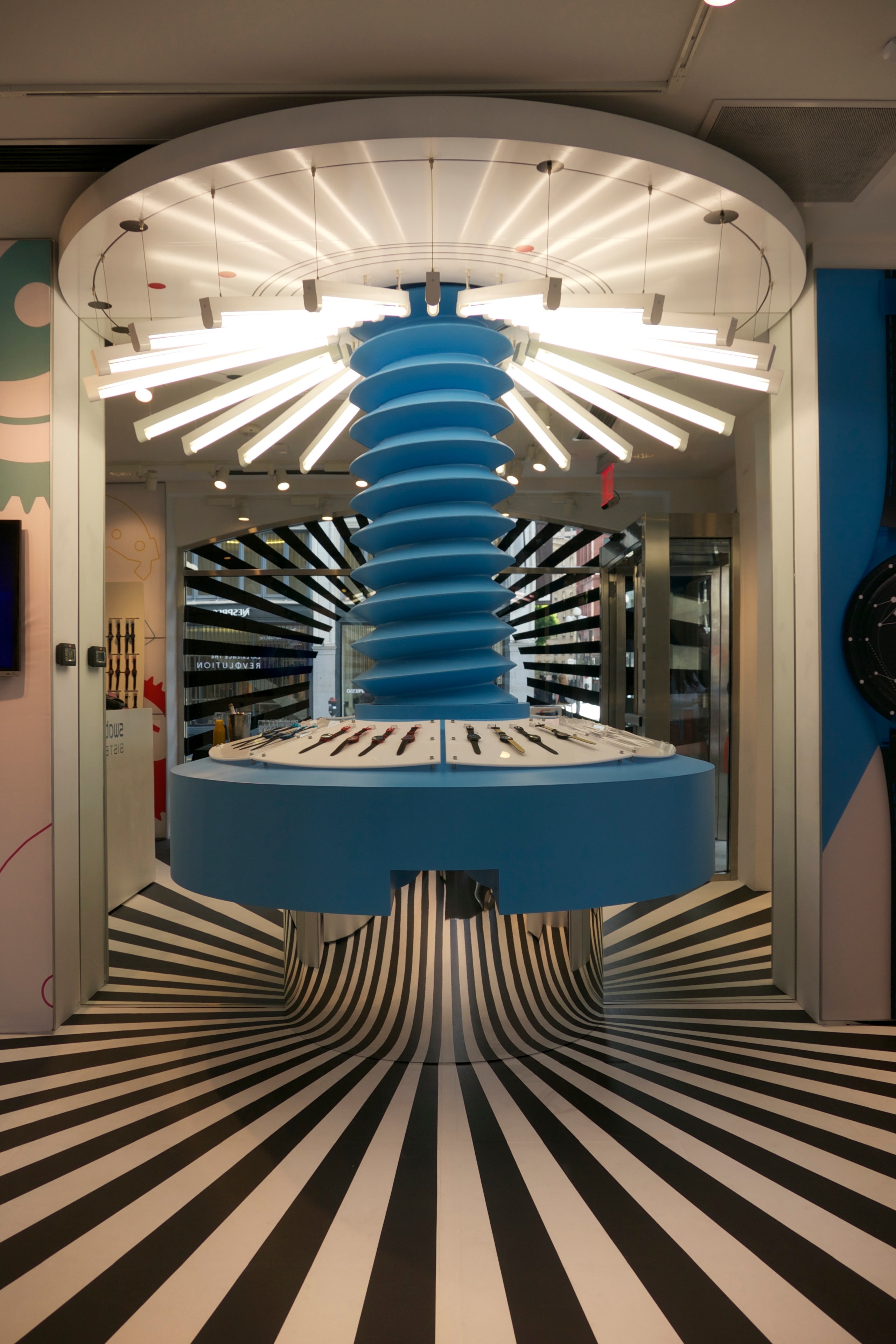 Futuristic watch display with blue sculpture