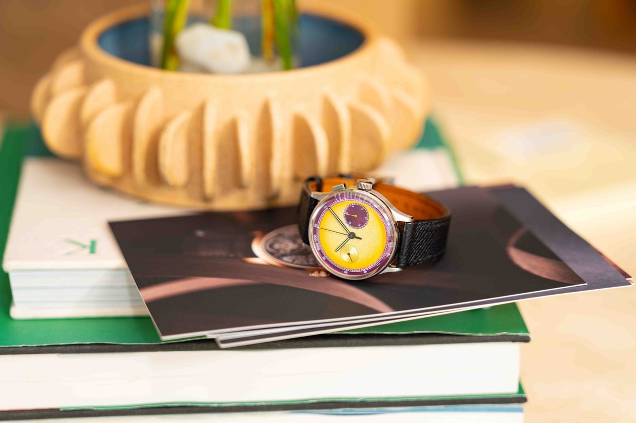 Luxury wristwatch on stacked magazines