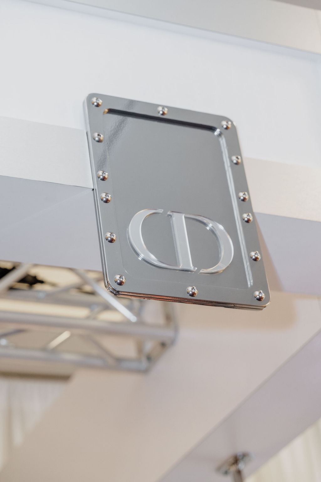 Chrome designer logo plaque on display stand