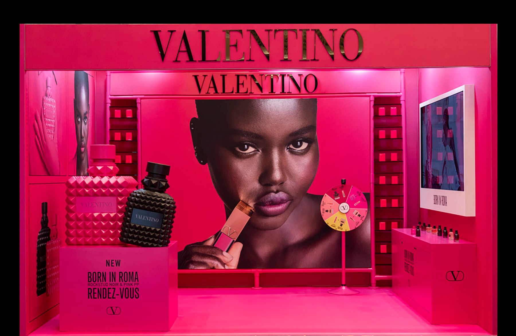 Valentino perfume display with beauty advertisement