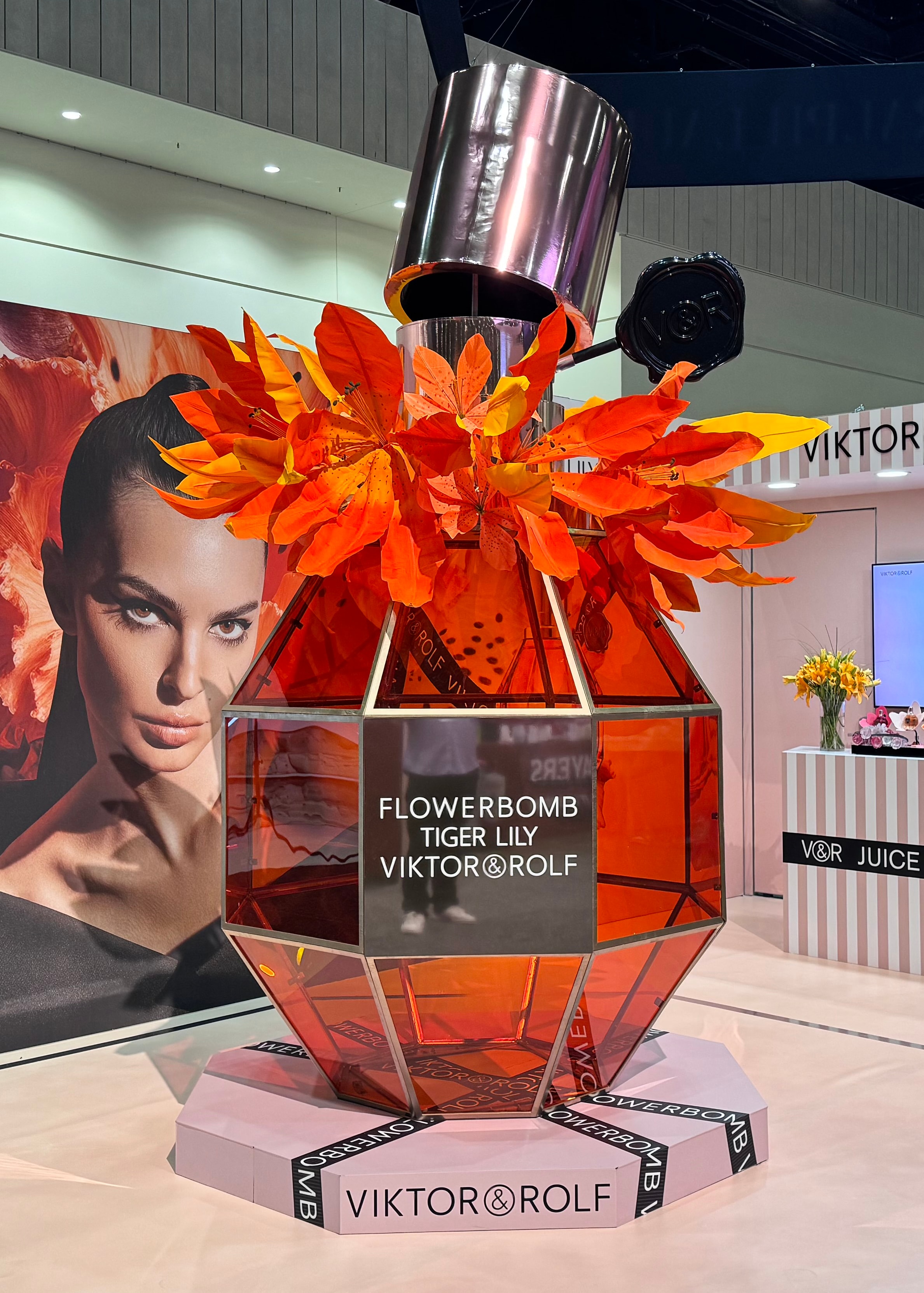 Giant perfume bottle with orange flowers display