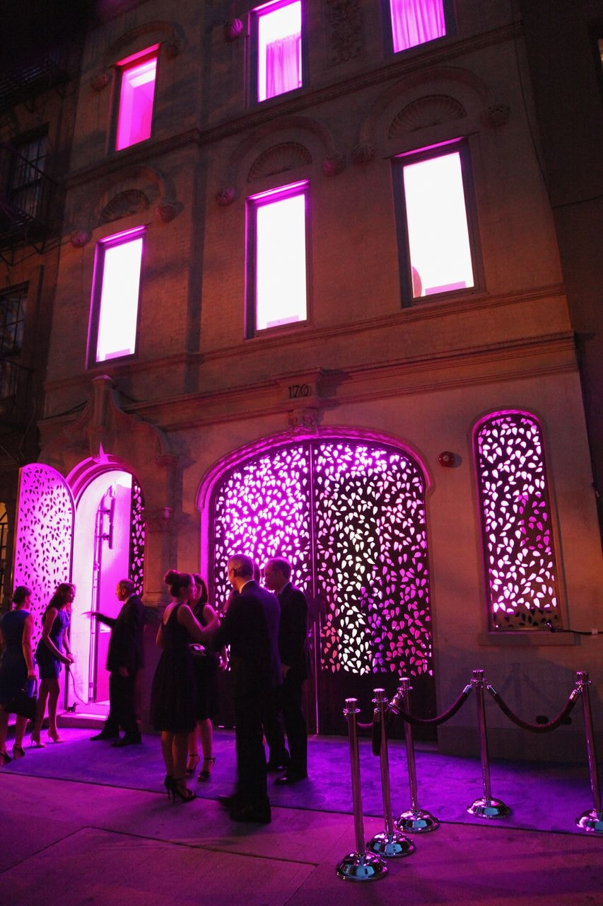 Guests outside a neon-lit event venue